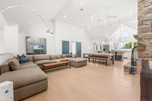 27 Quarry Rd, Stonington, CT 06355 - living room with high vaulted ceiling, light wood-style flooring, ceiling fan, a stone fireplace, and recessed lighting