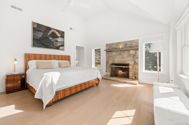 27 Quarry Rd, Stonington, CT 06355 - bedroom with wood finished floors, a stone fireplace, high vaulted ceiling, and ceiling fan