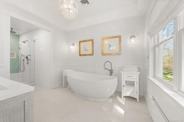 27 Quarry Rd, Stonington, CT 06355 - full bath with a walk in shower, a freestanding bath, tile patterned flooring, a chandelier, and wainscoting