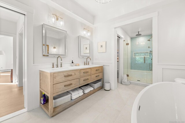 27 Quarry Rd, Stonington, CT 06355 - bathroom with a shower stall, double vanity, tile patterned floors, a soaking tub, and wainscoting