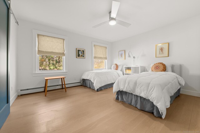 27 Quarry Rd, Stonington, CT 06355 - bedroom with a baseboard heating unit, wood finished floors, a ceiling fan, and baseboards