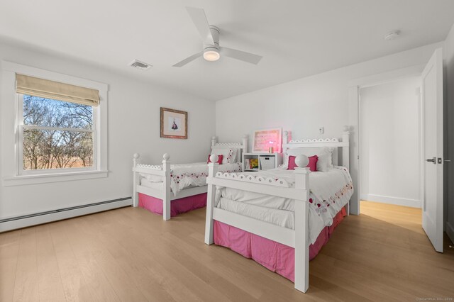 27 Quarry Rd, Stonington, CT 06355 - bedroom with wood finished floors, a baseboard heating unit, and a ceiling fan