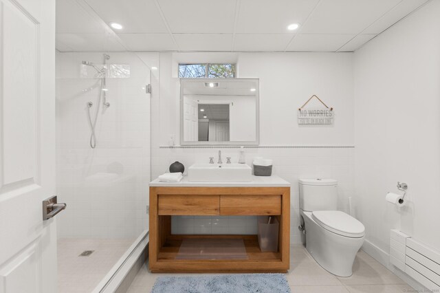 27 Quarry Rd, Stonington, CT 06355 - bathroom with toilet, vanity, a stall shower, tile patterned floors, and tile walls
