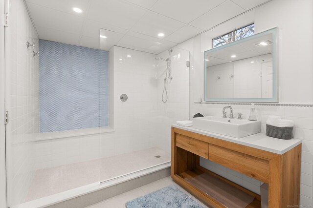 27 Quarry Rd, Stonington, CT 06355 - bathroom with walk in shower, tile walls, vanity, and tile patterned flooring