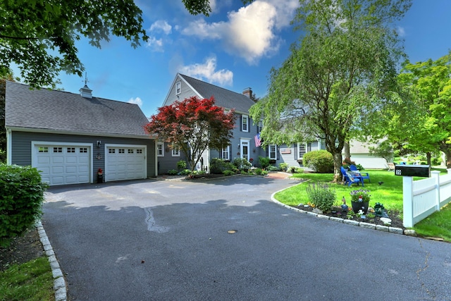 19 Old Colony Rd Unit 19, Monroe, CT 06468 - view of front of home featuring driveway, a garage, a front yard, and a chimney
