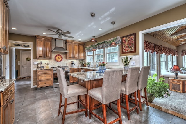 19 Old Colony Rd Unit 19, Monroe, CT 06468 - kitchen featuring stainless steel gas range, wall chimney exhaust hood, a sink, recessed lighting, and a breakfast bar