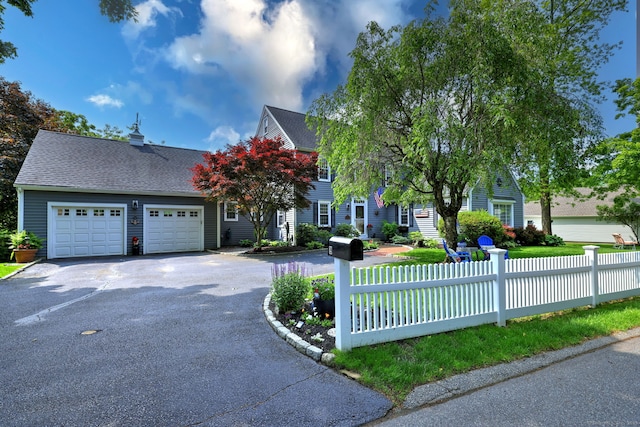 19 Old Colony Rd Unit 19, Monroe, CT 06468 - view of front of house featuring asphalt driveway, an attached garage, a chimney, and a shingled roof