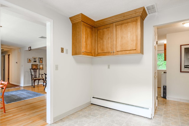 20 Wescott Rd, Simsbury, CT 06070 - laundry room featuring a baseboard radiator and baseboards