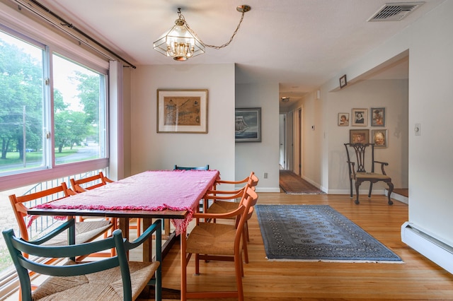 20 Wescott Rd, Simsbury, CT 06070 - dining area featuring a baseboard radiator, wood finished floors, a chandelier, and baseboards