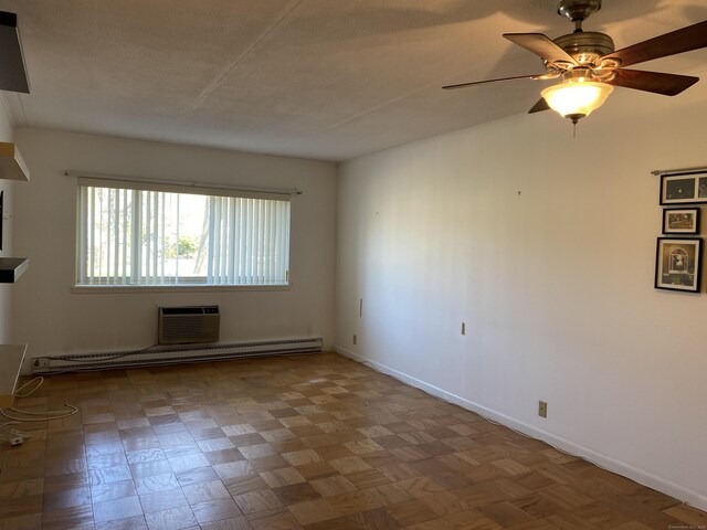 1700 Broadbridge Ave Unit A16, Stratford, CT 06614 - spare room with ceiling fan, baseboards, a baseboard radiator, and a wall mounted air conditioner