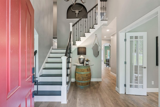 86 Charolais Way, Burlington, CT 06013 - entryway featuring stairs, baseboards, wood finished floors, arched walkways, and a towering ceiling