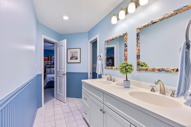 86 Charolais Way, Burlington, CT 06013 - bathroom with wainscoting, double vanity, tile patterned flooring, and connected bathroom