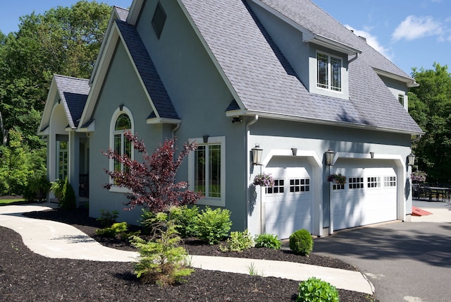 86 Charolais Way, Burlington, CT 06013 - view of front of house with a garage, stucco siding, driveway, and a shingled roof