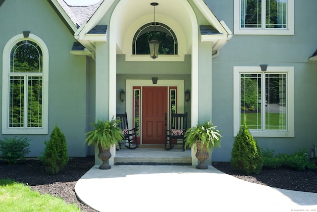 86 Charolais Way, Burlington, CT 06013 - view of exterior entry with stucco siding and a shingled roof