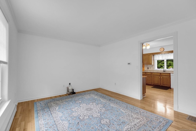36 Holly Ln, Middletown, CT 06457 - empty room featuring light wood-style floors, baseboard heating, and crown molding