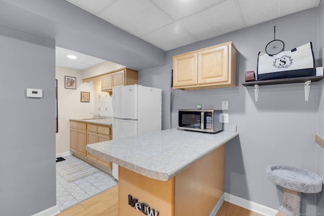 36 Holly Ln, Middletown, CT 06457 - kitchen featuring stainless steel microwave, light brown cabinets, light countertops, a peninsula, and recessed lighting