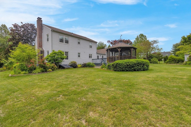 36 Holly Ln, Middletown, CT 06457 - back of property featuring a chimney, a gazebo, and a yard