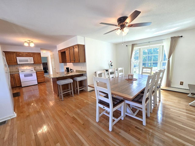 36 Holly Ln, Middletown, CT 06457 - dining area with light wood-style flooring, a ceiling fan, and baseboard heating