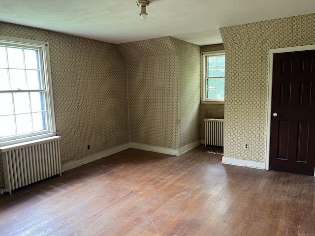 63 Park Rd, Hamden, CT 06517 - bonus room featuring radiator, wood finished floors, baseboards, and wallpapered walls