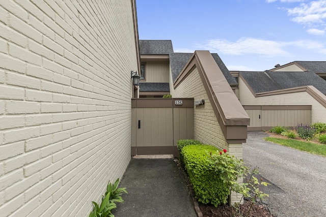 85 Viscount Dr Unit 15C, Milford, CT 06460 - view of side of home with a shingled roof and brick siding