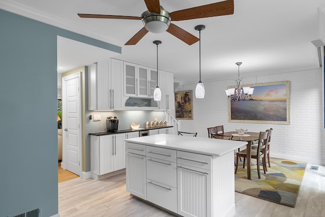 85 Viscount Dr Unit 15C, Milford, CT 06460 - kitchen featuring light wood-style floors, ceiling fan, white cabinets, brick wall, and crown molding