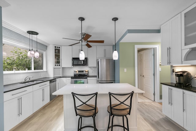 85 Viscount Dr Unit 15C, Milford, CT 06460 - kitchen featuring stainless steel appliances, a ceiling fan, tasteful backsplash, a sink, and ornamental molding