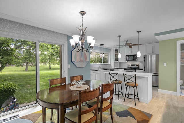 85 Viscount Dr Unit 15C, Milford, CT 06460 - dining space featuring a ceiling fan, light wood-style floors, and a chandelier