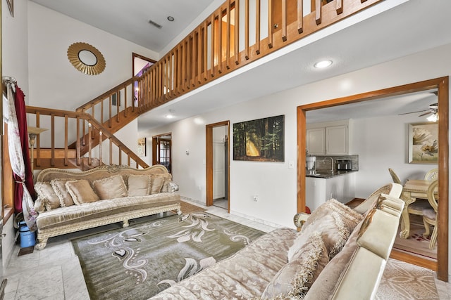 3 Jeffrey Alan Dr, Manchester, CT 06042 - living room with stairs, ceiling fan, a towering ceiling, and baseboards