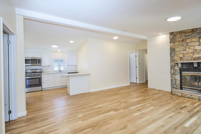 10 Crescent Park Rd, Westport, CT 06880 - unfurnished living room with light wood-style floors and a stone fireplace