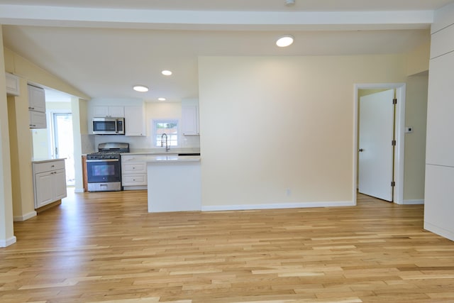 10 Crescent Park Rd, Westport, CT 06880 - kitchen with stainless steel appliances, white cabinetry, light wood finished floors, light countertops, and recessed lighting