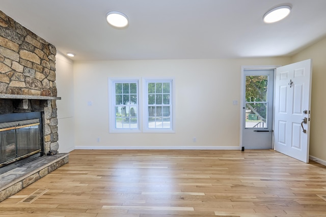 10 Crescent Park Rd, Westport, CT 06880 - unfurnished living room with light wood-style flooring and a stone fireplace