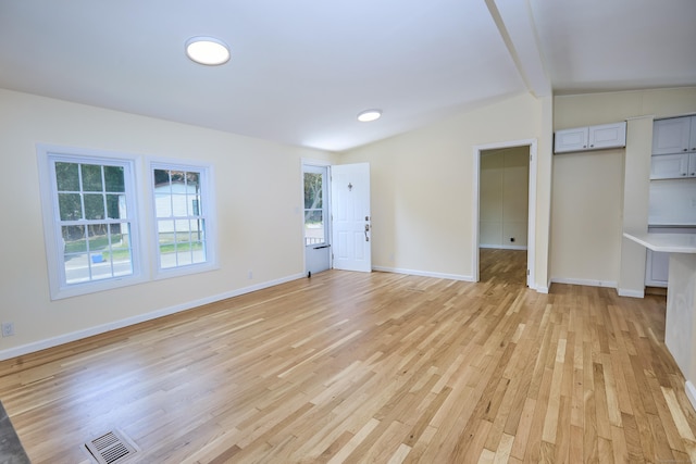 10 Crescent Park Rd, Westport, CT 06880 - unfurnished living room with vaulted ceiling and light wood-style floors