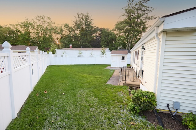 10 Crescent Park Rd, Westport, CT 06880 - yard at dusk featuring a fenced backyard, a shed, and view of wooded area