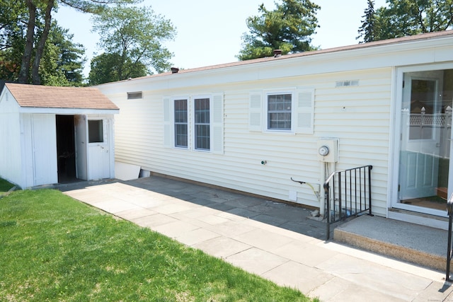 10 Crescent Park Rd, Westport, CT 06880 - rear view of house with a shed, a patio, and a yard