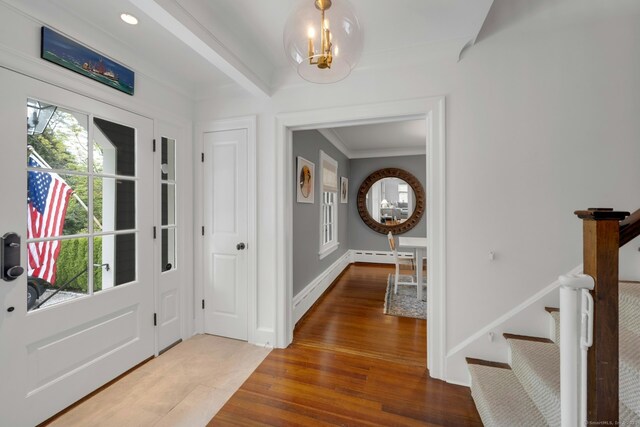 6 Prescott Ln, Greenwich, CT 06830 - entryway with a chandelier, stairs, wood finished floors, crown molding, and a baseboard radiator