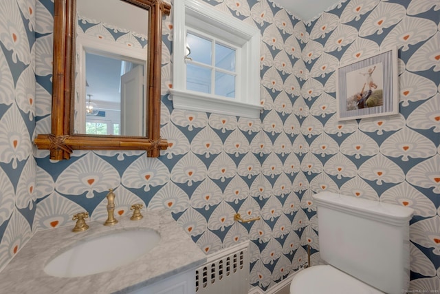6 Prescott Ln, Greenwich, CT 06830 - half bath with radiator heating unit, toilet, vanity, and wallpapered walls