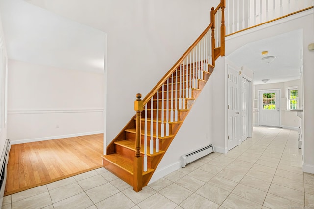 22 Loomis Dr, Coventry, CT 06238 - staircase with baseboard heating, tile patterned flooring, a baseboard radiator, and baseboards