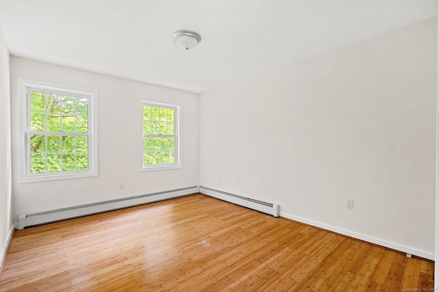 22 Loomis Dr, Coventry, CT 06238 - spare room with light wood-style floors, baseboards, and a baseboard radiator