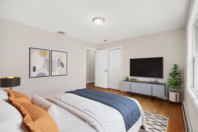 22 Loomis Dr, Coventry, CT 06238 - bedroom with a baseboard radiator, light wood-style floors, a closet, and baseboards