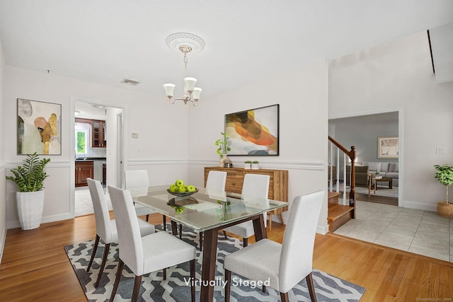 22 Loomis Dr, Coventry, CT 06238 - dining room with stairs, a chandelier, and light wood-style flooring