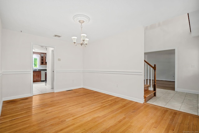 22 Loomis Dr, Coventry, CT 06238 - unfurnished room featuring a chandelier, stairway, light wood-style flooring, and baseboards