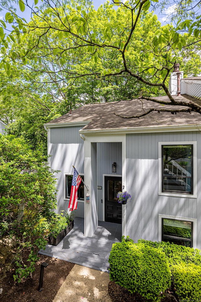 45 Ettl Ln Unit 301, Greenwich, CT 06831 - doorway to property featuring roof with shingles and a chimney