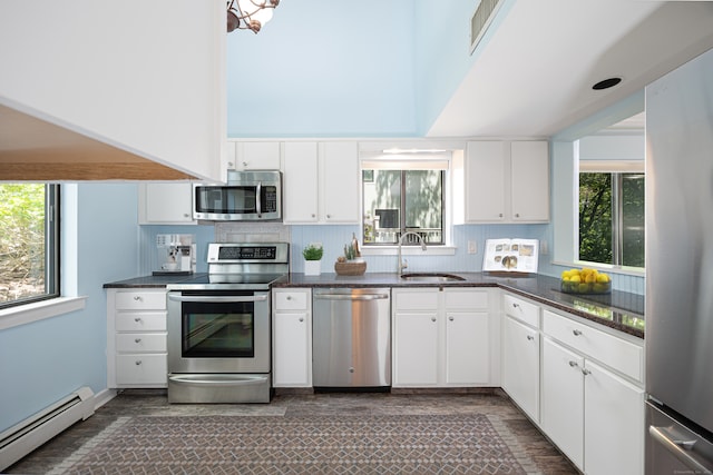 45 Ettl Ln Unit 301, Greenwich, CT 06831 - kitchen with stainless steel appliances, baseboard heating, a sink, and white cabinetry
