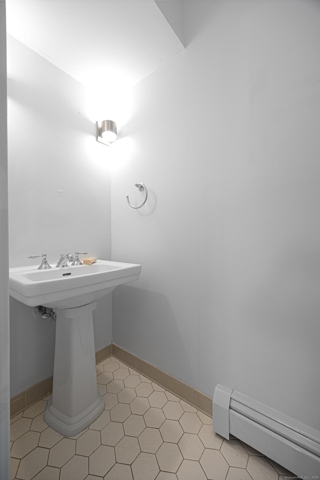 45 Ettl Ln Unit 301, Greenwich, CT 06831 - bathroom with a baseboard heating unit, a sink, tile patterned flooring, and baseboards