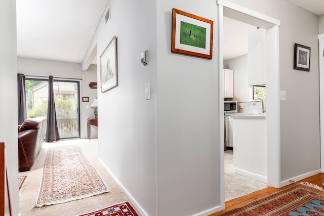 21 Heritage Vlg Unit B, Southbury, CT 06488 - hallway featuring baseboards and a sink