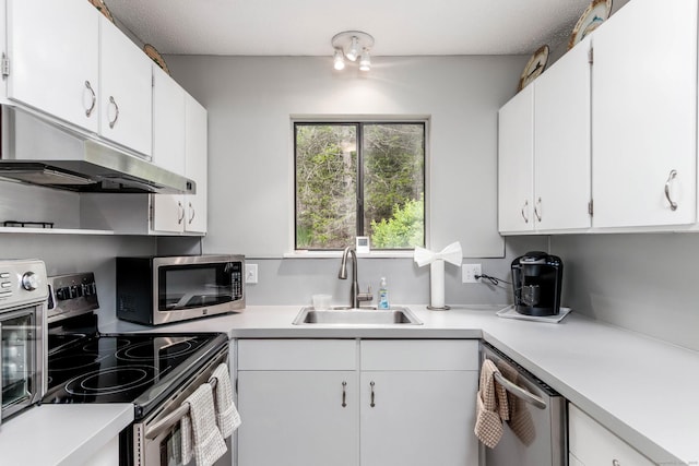 21 Heritage Vlg Unit B, Southbury, CT 06488 - kitchen featuring stainless steel appliances, a sink, under cabinet range hood, light countertops, and white cabinets
