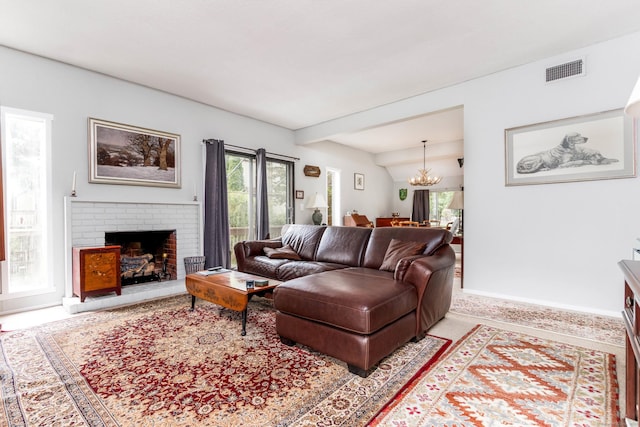 21 Heritage Vlg Unit B, Southbury, CT 06488 - carpeted living area featuring a chandelier, plenty of natural light, a fireplace, and baseboards