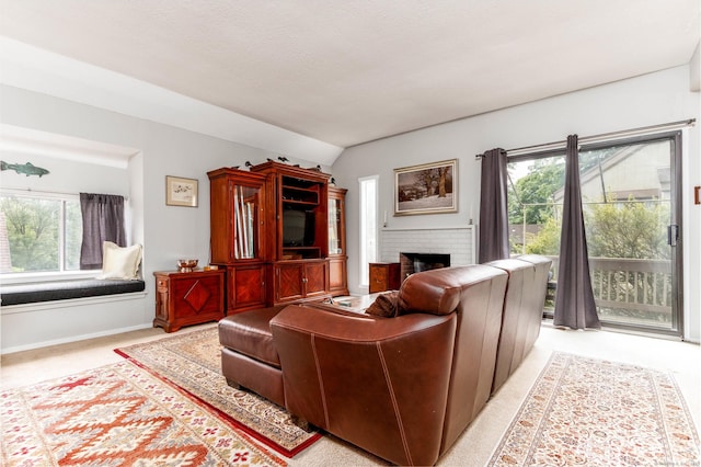 21 Heritage Vlg Unit B, Southbury, CT 06488 - living area featuring a fireplace, light colored carpet, baseboards, and vaulted ceiling