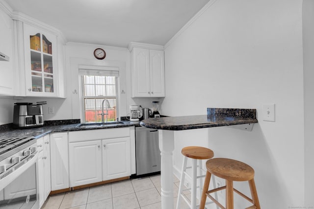151 Alsace St, Bridgeport, CT 06604 - kitchen with appliances with stainless steel finishes, a sink, a kitchen breakfast bar, white cabinets, and light tile patterned floors