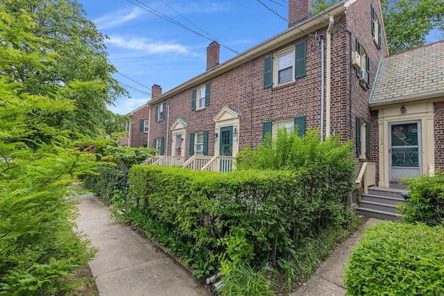 151 Alsace St, Bridgeport, CT 06604 - view of side of property with a chimney, brick siding, and a high end roof